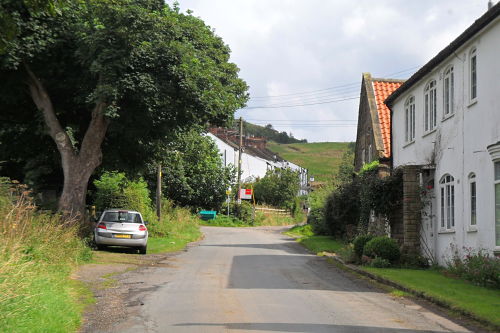The road goes left at the end, the steepest section now follows