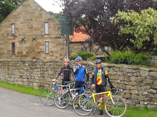Ian, Dave and Paul (left to right) posing for a picture outside the legendary Bell End Farm just before the gradient increases. Rob chose to take the pic.